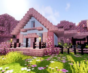 A pink, cherry wood Minecraft house design built in a cherry grove biome.