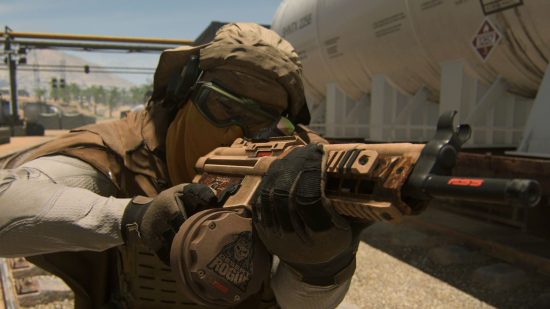 Warzone 2 Strongholds and Black Sites: An armoured soldier wielding a Desert Rogue weapon on a deserted railway track in Al Mazrah, the Warzone 2 map.